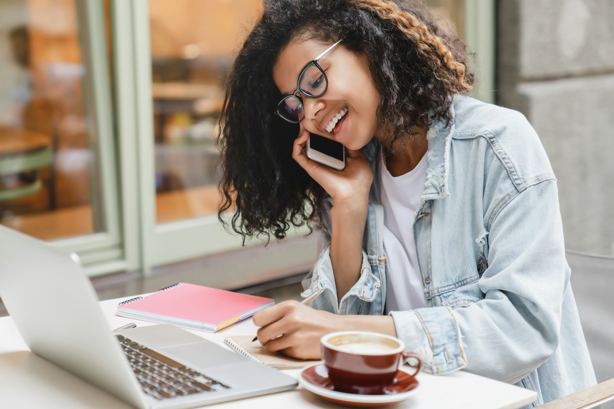 Young successful african-american businesswoman student working on laptop remotely